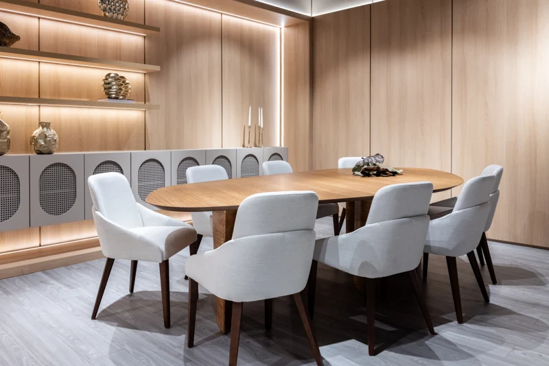 Dining table and illuminated shelving in the Hommes showroom